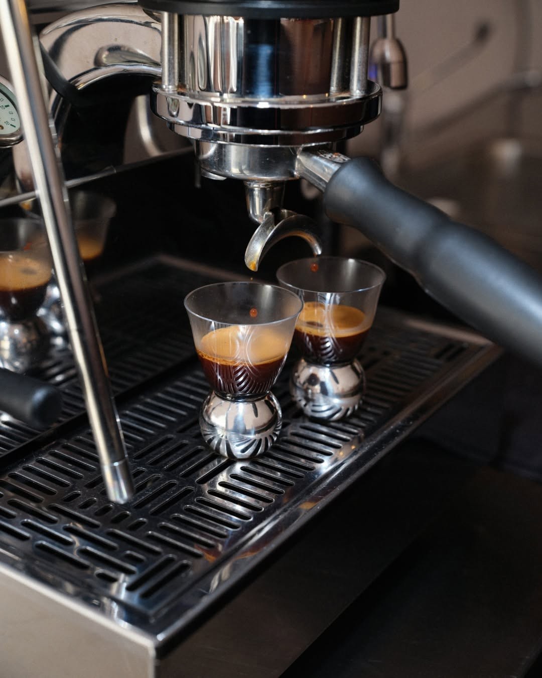 Espresso being prepared on a professional coffee machine